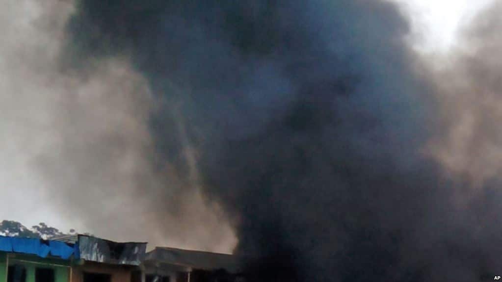 Smoke rises after a bomb blast at a bus terminal in Jos, Nigeria, Tuesday, May 20, 2014. Two explosions ripped through a bustling bus terminal and market frequented by thousands of people in Nigeria's central city of Jos on Tuesday afternoon, and police said there are an unknown number of casualties. The blasts could be heard miles away and clouds of black smoke rose above the city as firefighters and rescue workers struggled to reach the area as thousands of people fled. (AP Photo/Stefanos Foundation)